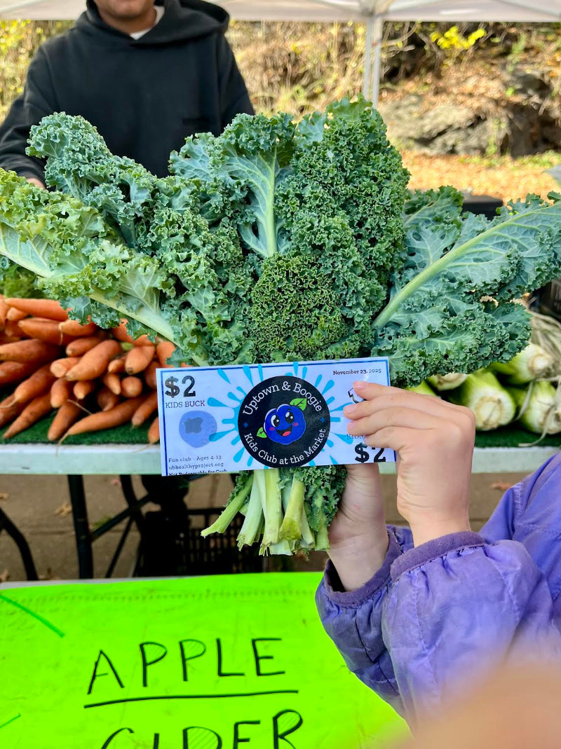 kids buck held in front of kale